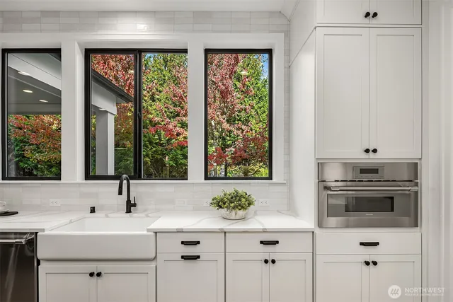 a kitchen with a sink stove and cabinets