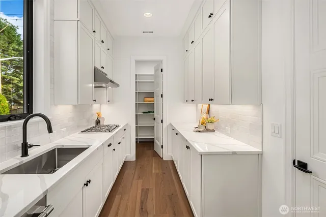 a kitchen with a sink stove and cabinets