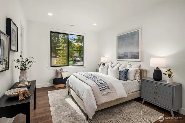 a bedroom with a large bed and a window