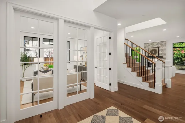 a view of entryway with wooden floor and windows