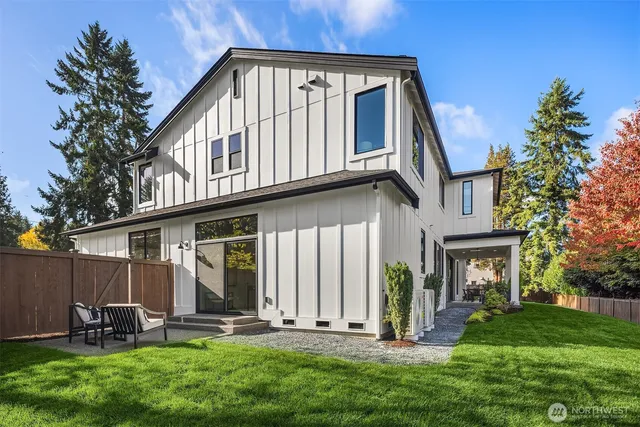 a view of a house with a yard and sitting area