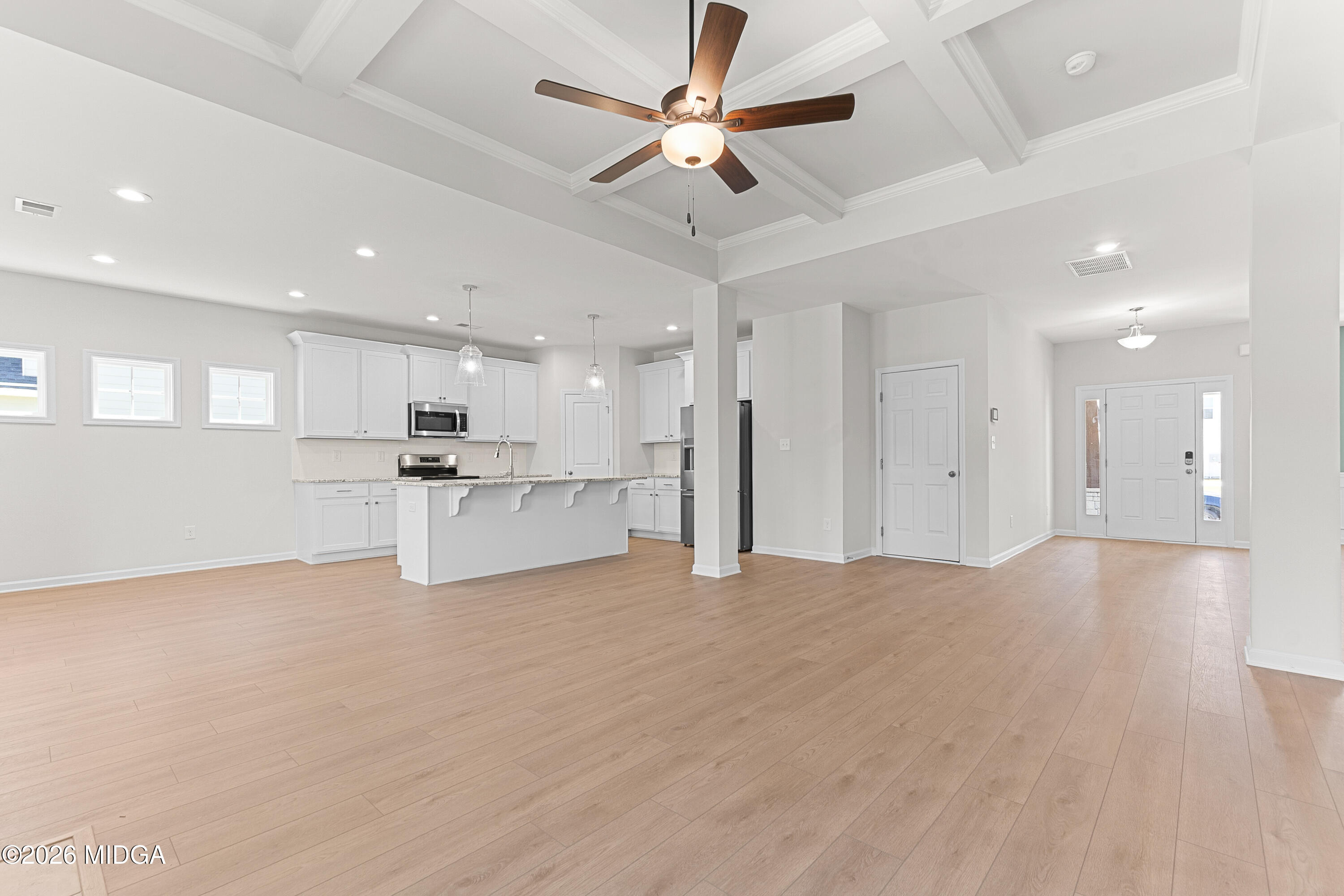 5393 Felles Way, Unit 359 Forsyth, GA 31029 - Photo 11 of 54 a view of an empty room with kitchen appliances and a ceiling fan