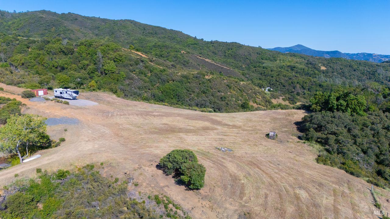 31909 Green Road Cloverdale, CA 95425 - Photo 9 of 25 a view of a dry yard with mountains in the background