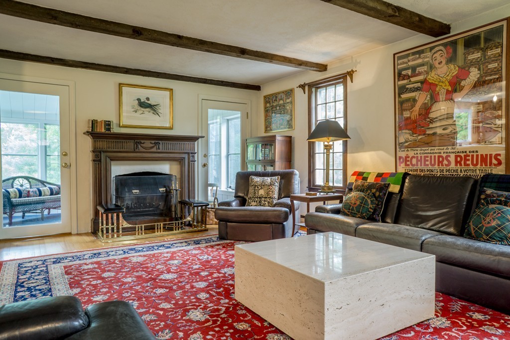 500 Lexington Road Concord, MA 01742 - Photo 2 of 14 a living room with furniture and a fireplace