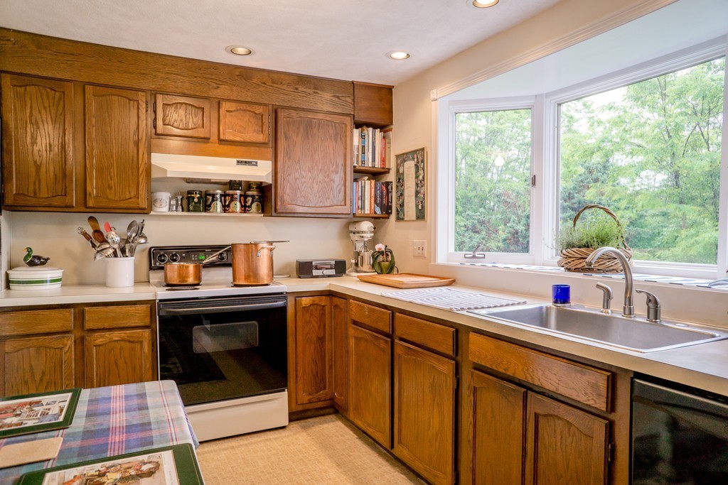 500 Lexington Road Concord, MA 01742 - Photo 4 of 14 a kitchen with a sink stove and cabinets