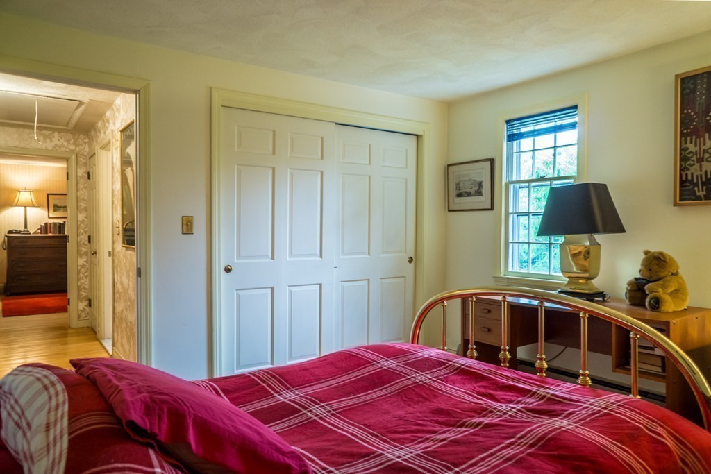 500 Lexington Road Concord, MA 01742 - Photo 8 of 14 a bedroom with a bed and a mirror
