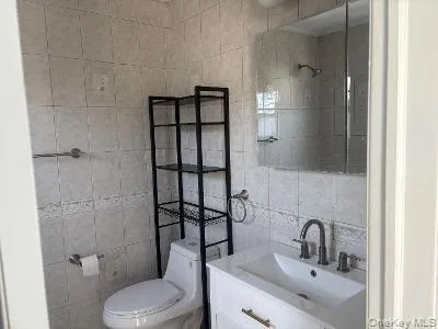 a bathroom with a toilet sink and shower