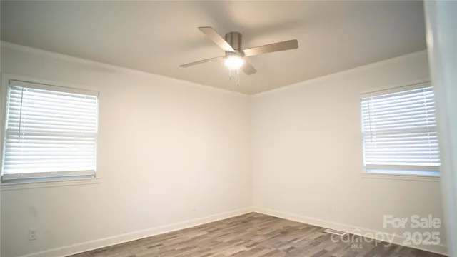 a view of a room with wooden floor and natural light