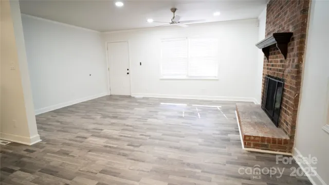 wooden floor in an empty room with a fireplace