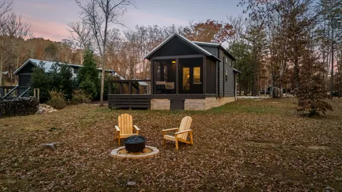 a view of a house with a yard and wooden fence