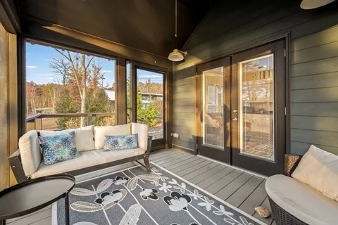 a view of a backyard with table and chairs with wooden fence