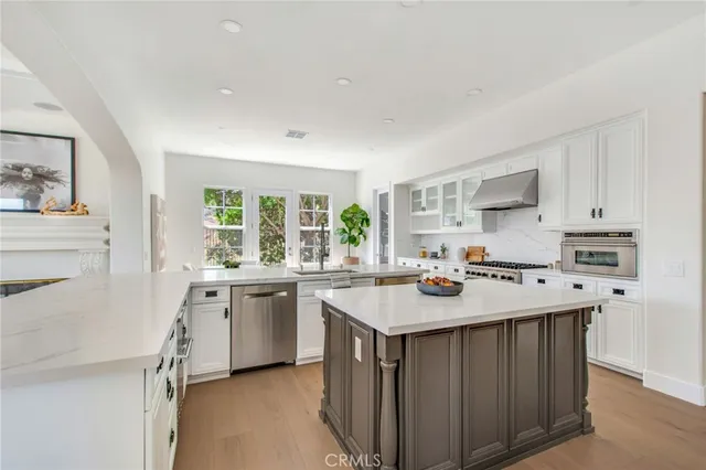 a kitchen with a stove a sink a refrigerator and cabinets