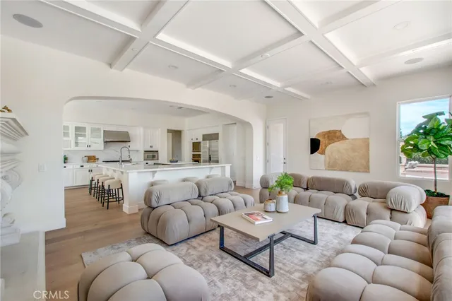 a living room with furniture and view of kitchen