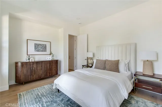 a bedroom with a bed and painting on the wall