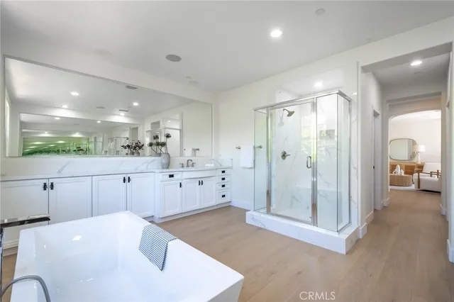 a kitchen with white cabinets and window