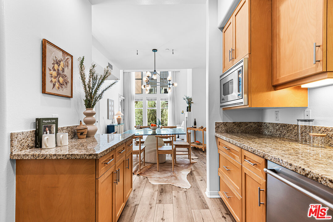 4050 Glencoe Avenue, Unit 414 Marina del Rey, CA 90292 - Photo 11 of 31 a kitchen with granite countertop a sink stove and cabinets