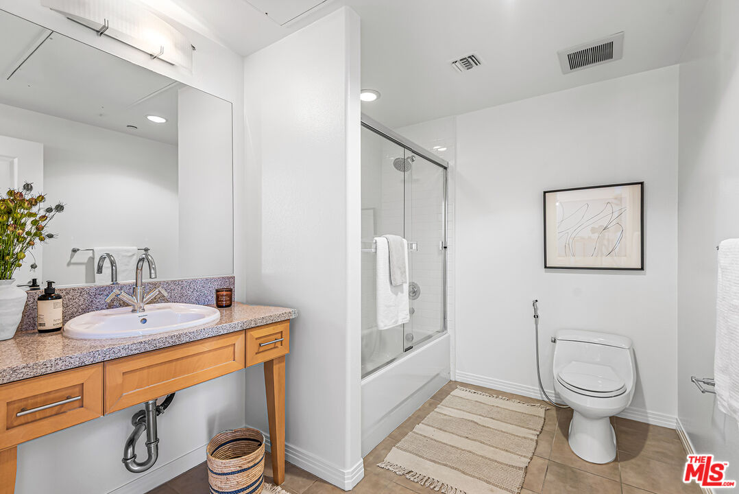 4050 Glencoe Avenue, Unit 414 Marina del Rey, CA 90292 - Photo 14 of 31 a bathroom with a sink toilet and shower