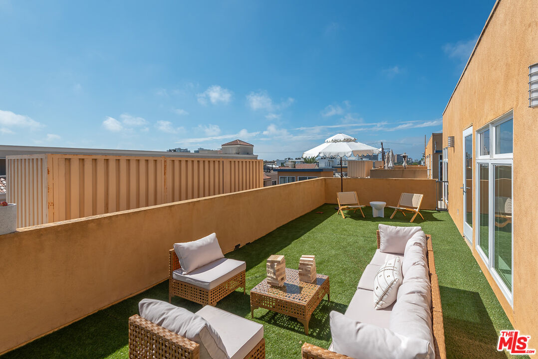 4050 Glencoe Avenue, Unit 414 Marina del Rey, CA 90292 - Photo 4 of 31 a view of a patio with couches chairs and a floor to ceiling window