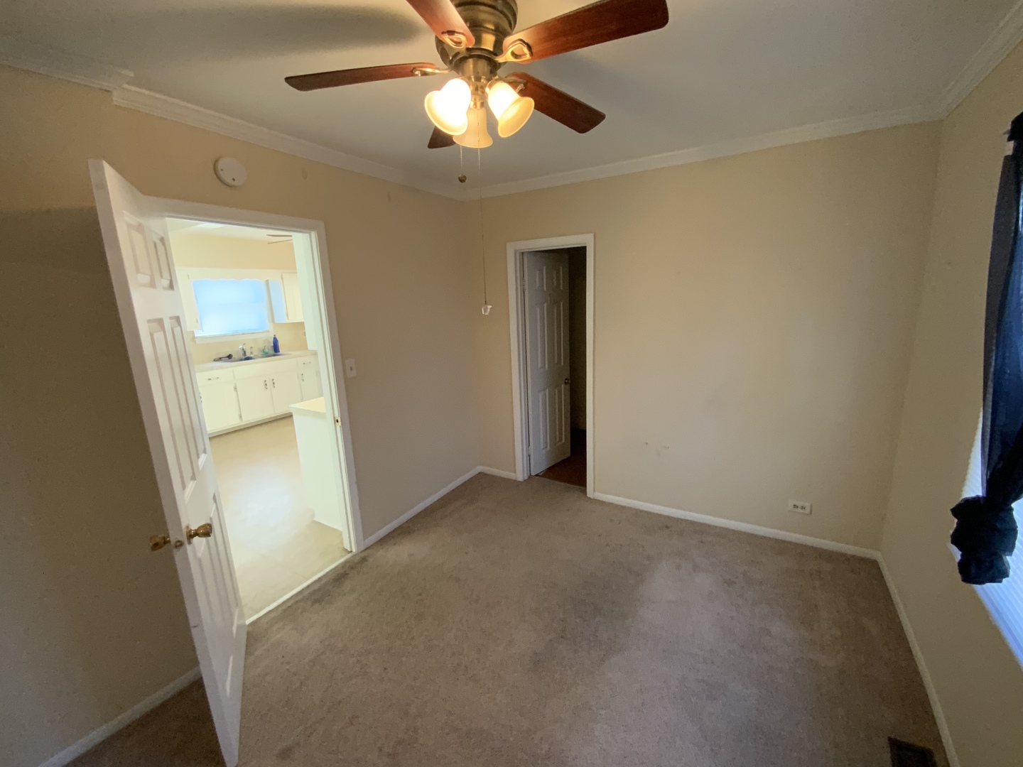 321 West Joe Orr Road Chicago Heights, IL 60411 - Photo 13 of 36 an empty room with a ceiling fan and a bathroom