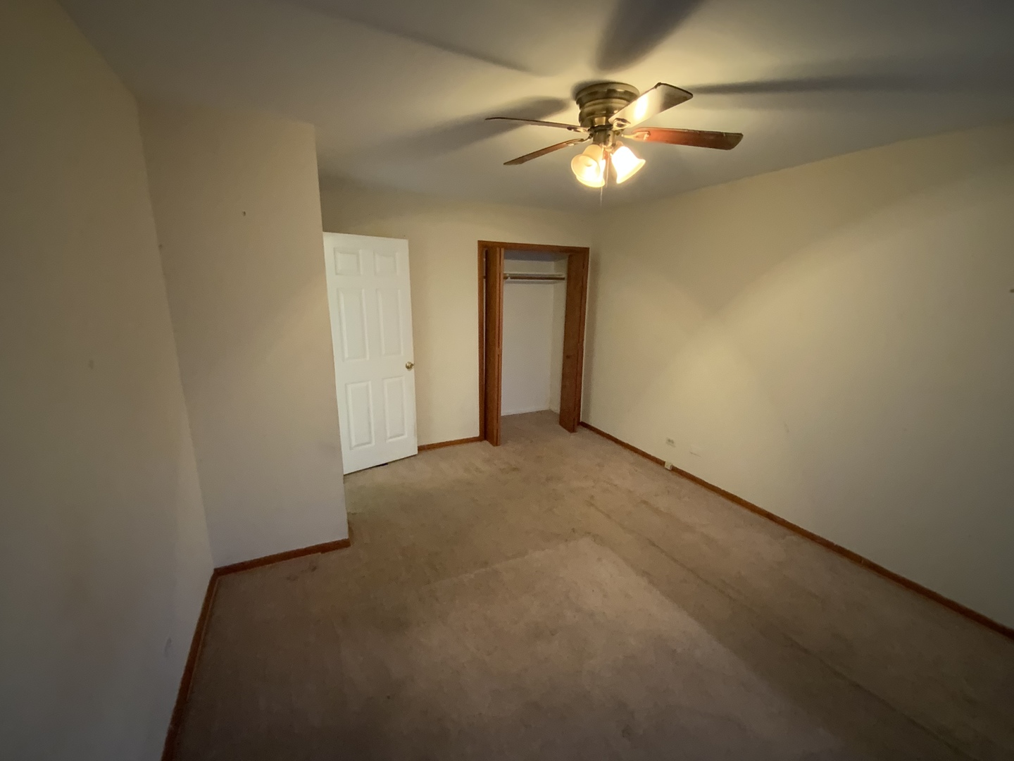 321 West Joe Orr Road Chicago Heights, IL 60411 - Photo 17 of 36 an empty room with a chandelier fan and windows