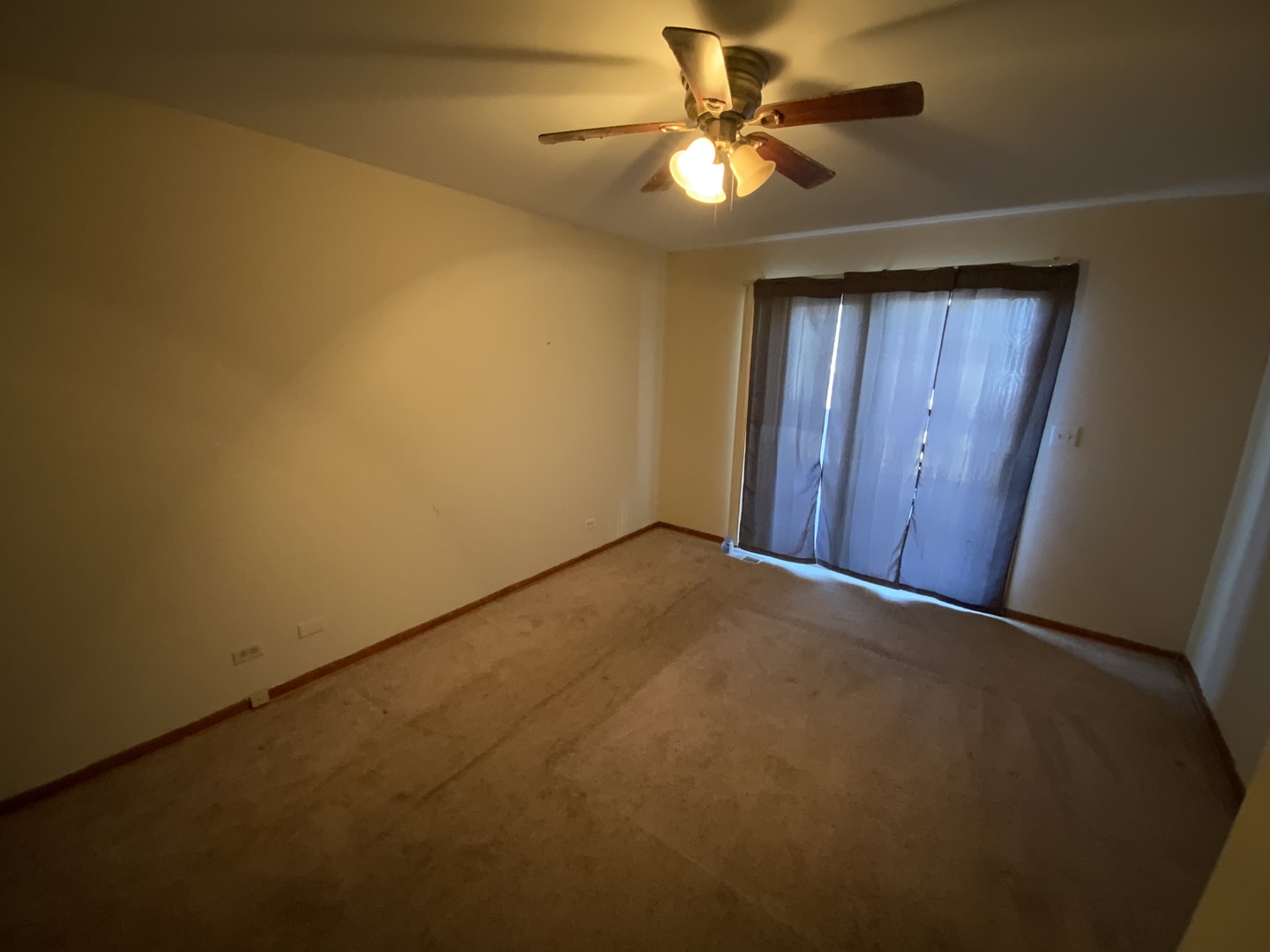 321 West Joe Orr Road Chicago Heights, IL 60411 - Photo 18 of 36 an empty room with a chandelier fan and windows