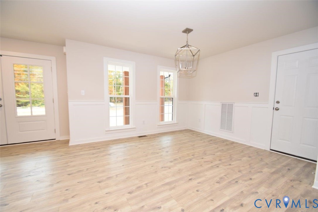 375 Amick Road Louisa, VA 23093 - Photo 6 of 25 a view of an empty room with wooden floor and a window