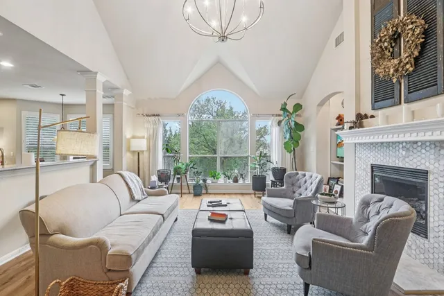 a kitchen with stainless steel appliances granite countertop a sink a stove and a wooden floors