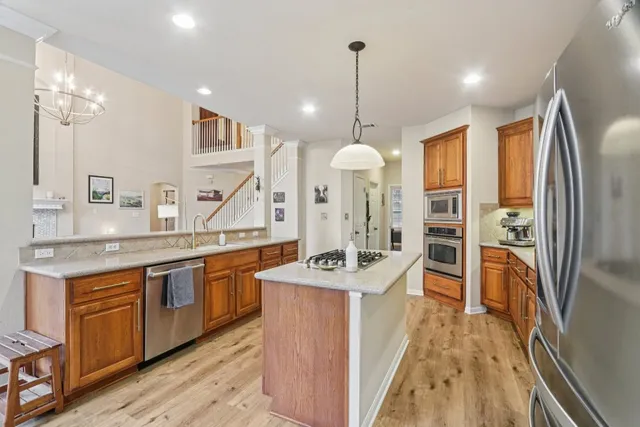 a spacious bedroom with a bed and a chandelier