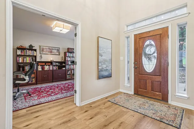a living room with furniture chandelier and a large window