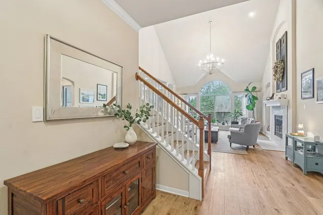 a living room with furniture a fireplace and a large window