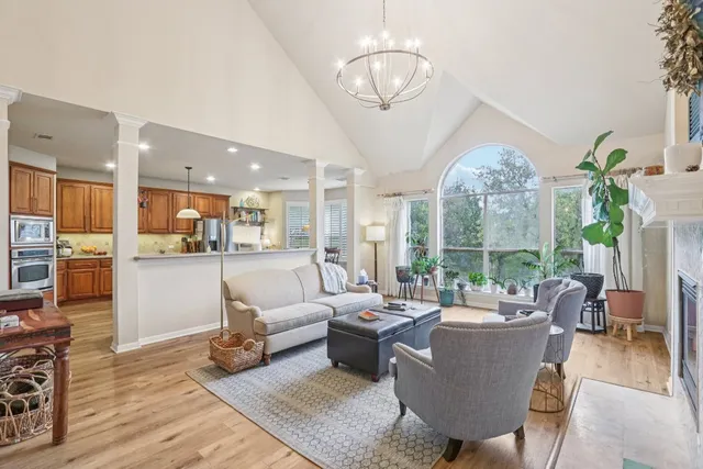 a kitchen with stainless steel appliances kitchen island granite countertop dining table chairs sink and cabinets