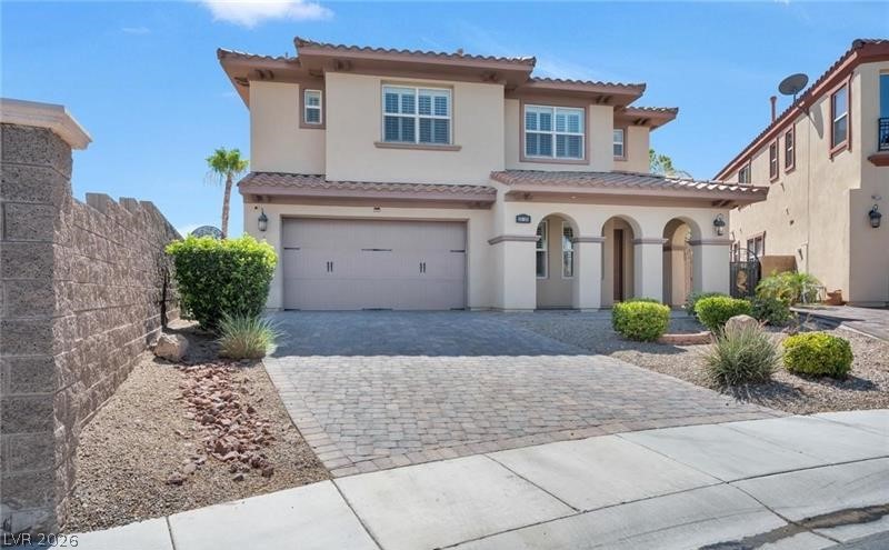 3 Tall Ruff Drive Las Vegas, NV 89148 - Photo 2 of 54 A well-manicured yard and paved driveway lead to this charming two-story stucco residence with arched entryway.