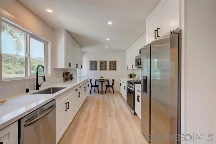 265 Wilkinson Drive San Marcos, CA 92078 - Photo 4 of 34 a large kitchen with a large window and stainless steel appliances