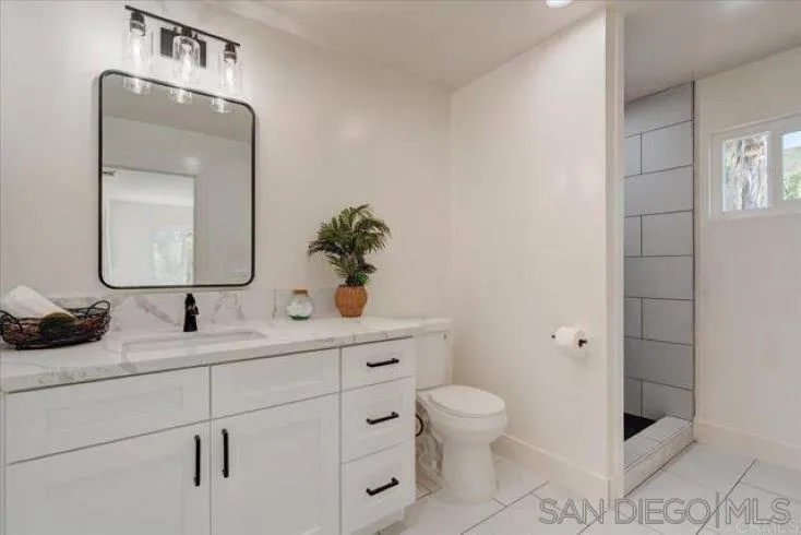 265 Wilkinson Drive San Marcos, CA 92078 - Photo 9 of 34 a bathroom with a toilet sink and mirror
