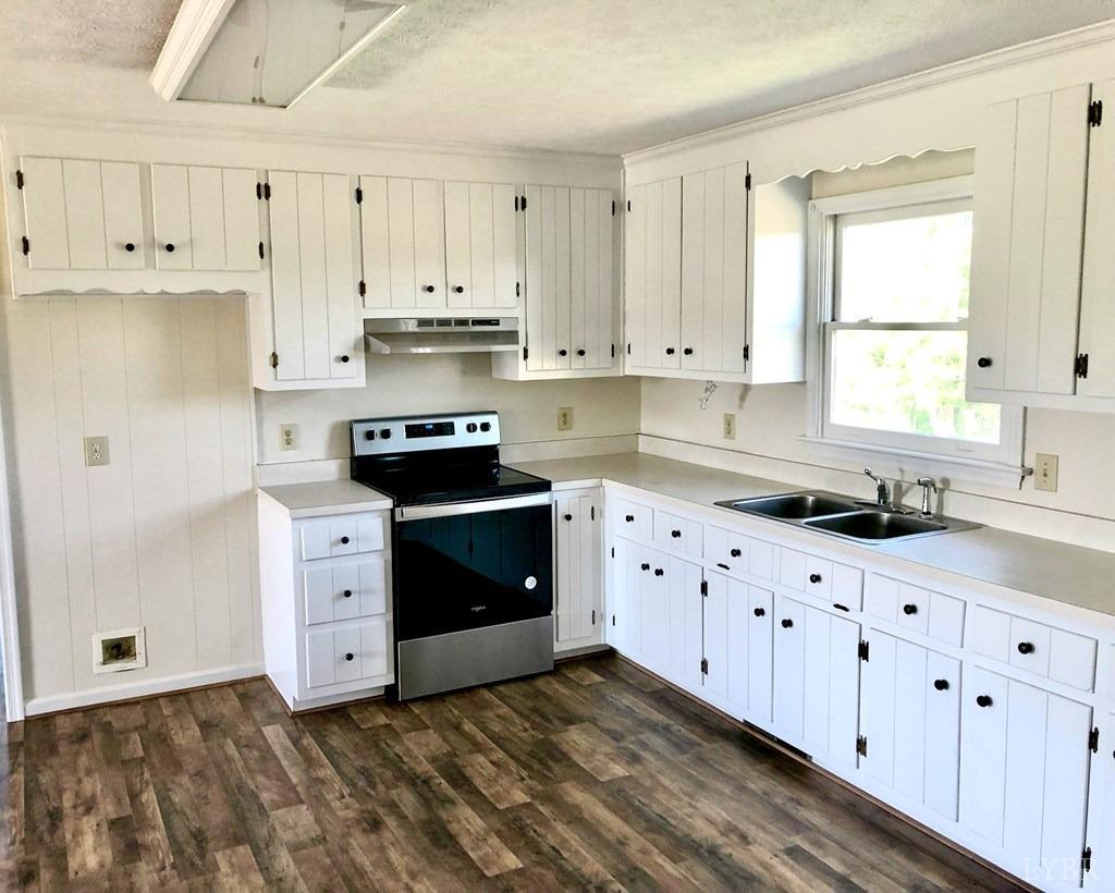 2568 Five Forks Road Pamplin, VA 23958 - Photo 6 of 22 a kitchen with granite countertop white cabinets white stainless steel appliances with a sink and dishwasher