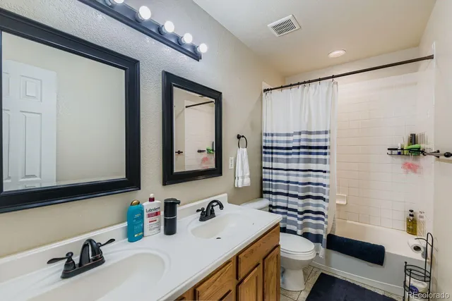 a bathroom with a sink double vanity and a mirror