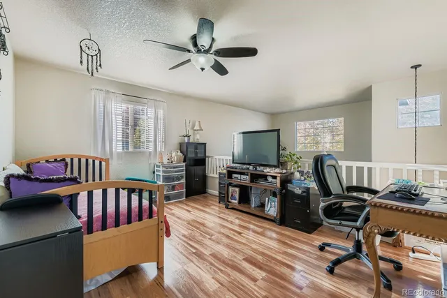 a view of a livingroom with workspace and a window