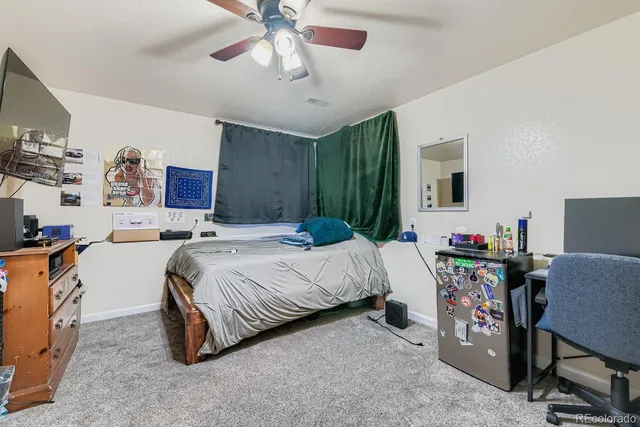 a bed room with a bed window and a chair