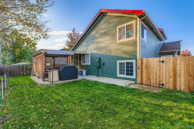 a front view of house with backyard and green space