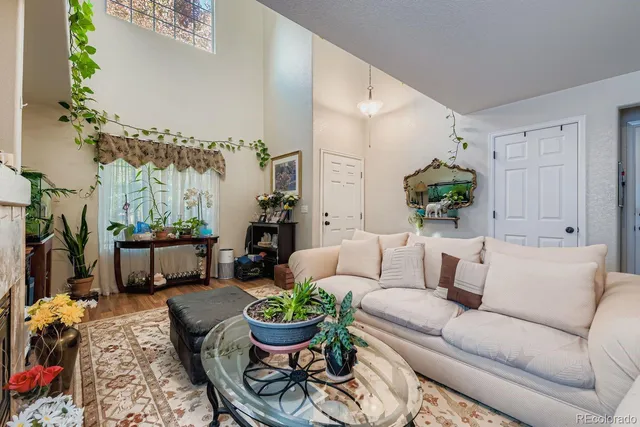 a living room with furniture and a painting on the wall