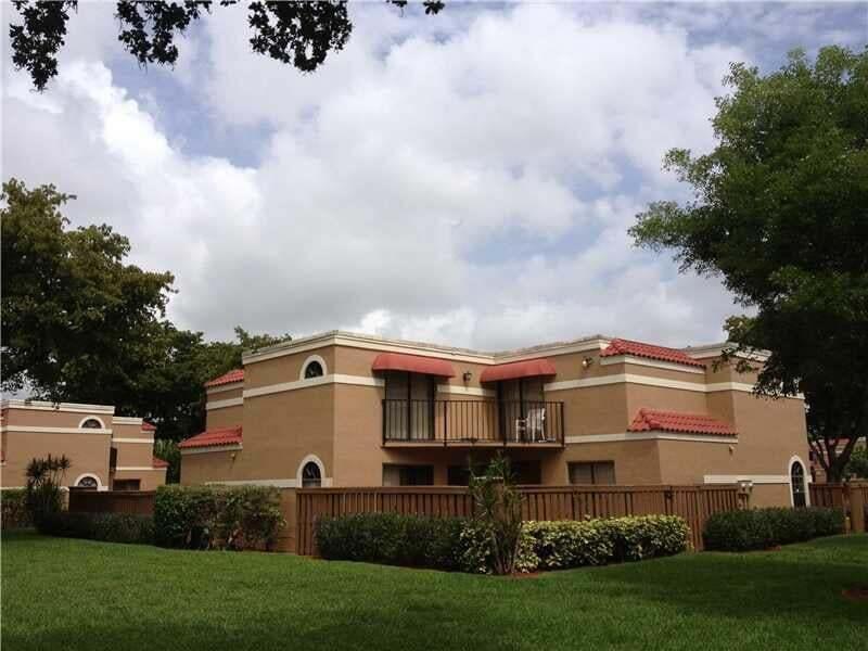 8183 Thames Boulevard, Unit B Boca Raton, FL 33433 - Photo 1 of 12 a front view of a house with a yard