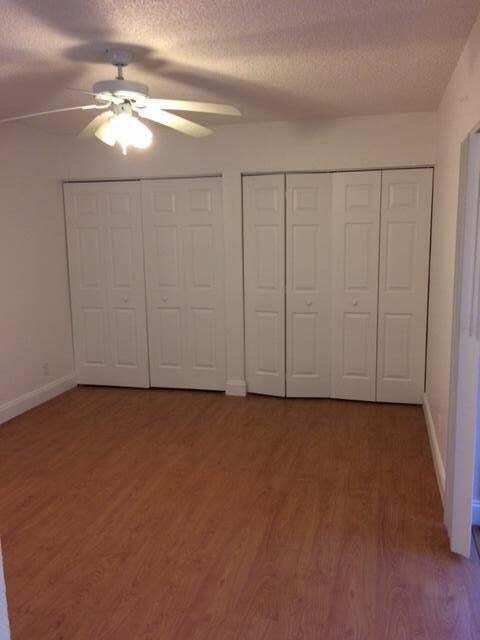 8183 Thames Boulevard, Unit B Boca Raton, FL 33433 - Photo 11 of 12 wooden floor in an empty room