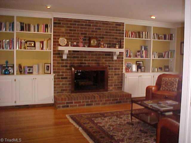 3107 St Regis Road Greensboro, NC 27408 - Photo 5 of 7 Other. Family room has built in shelving and shared fireplace.