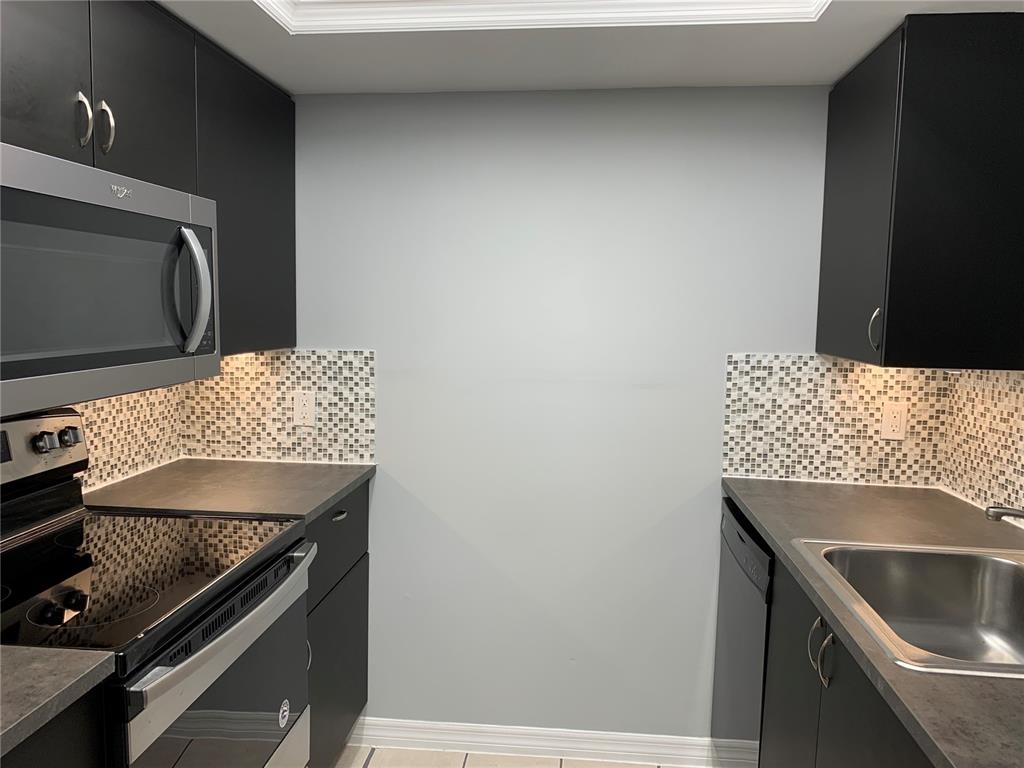 5754 Southwest 8th Place Gainesville, FL 32607 - Photo 5 of 29 a kitchen with a sink and a stove