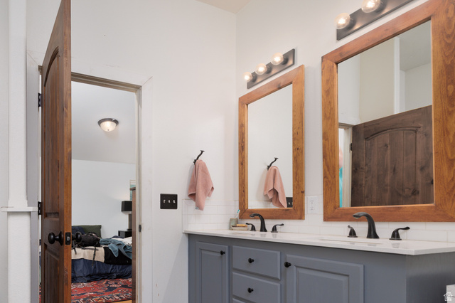 3902 Beaver Creek Road Kamas, UT 84036 - Photo 14 of 33 Full bath featuring double vanity, decorative backsplash, and connected bedroom