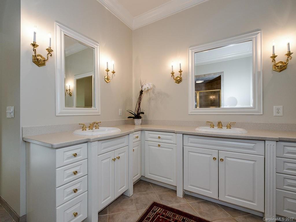 1911 Harris Road Charlotte, NC 28211 - Photo 11 of 24 a bathroom with a double vanity sink and mirror