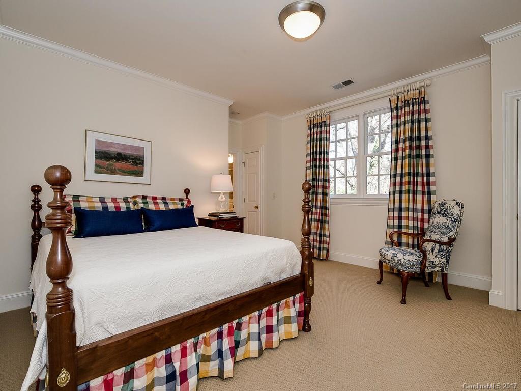 1911 Harris Road Charlotte, NC 28211 - Photo 14 of 24 a bed room with a bed and a chair