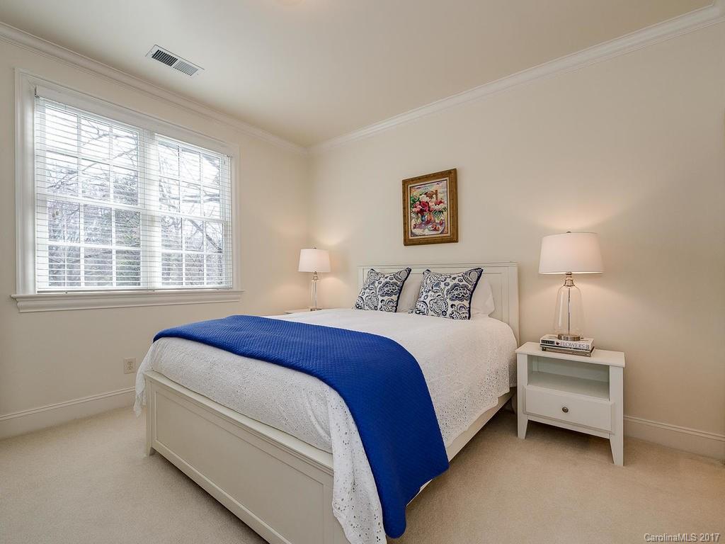 1911 Harris Road Charlotte, NC 28211 - Photo 16 of 24 a spacious bedroom with a bed and a window