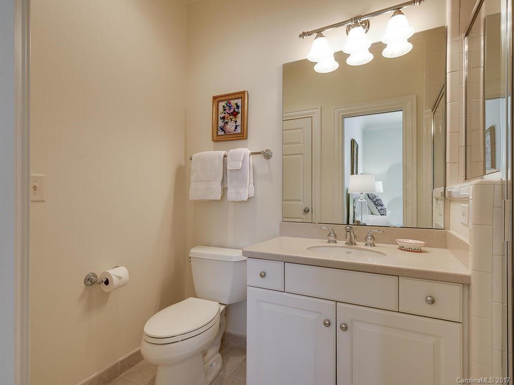1911 Harris Road Charlotte, NC 28211 - Photo 17 of 24 a bathroom with a sink vanity mirror and toilet