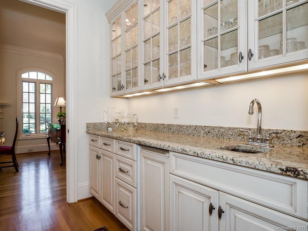 1911 Harris Road Charlotte, NC 28211 - Photo 4 of 24 a kitchen with stainless steel appliances granite countertop a sink and wooden floor